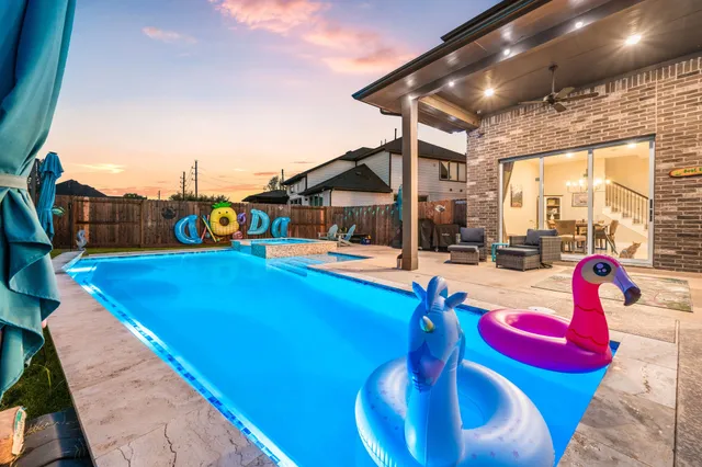 a outdoor space with pool table and chairs