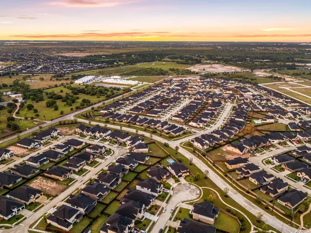 an aerial view of residential building and ocean