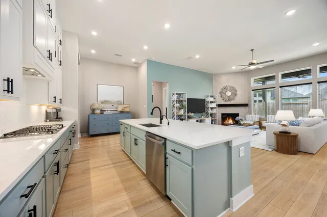 a large kitchen with stainless steel appliances lots of counter top space