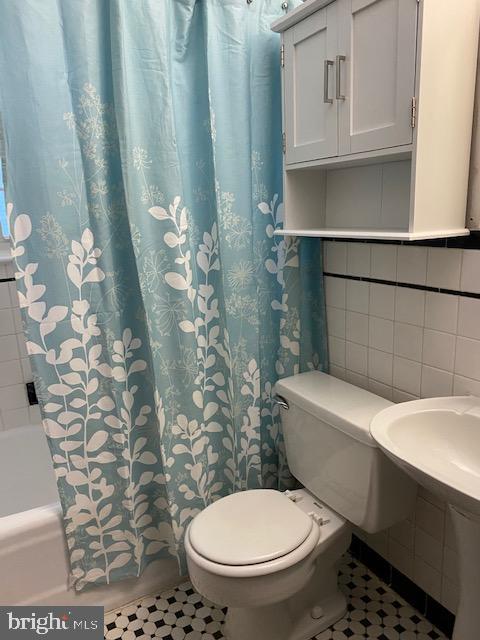 202 East Spring Street Alexandria, VA 22301 - Photo 13 of 45 a white toilet sitting next to a bathroom sink
