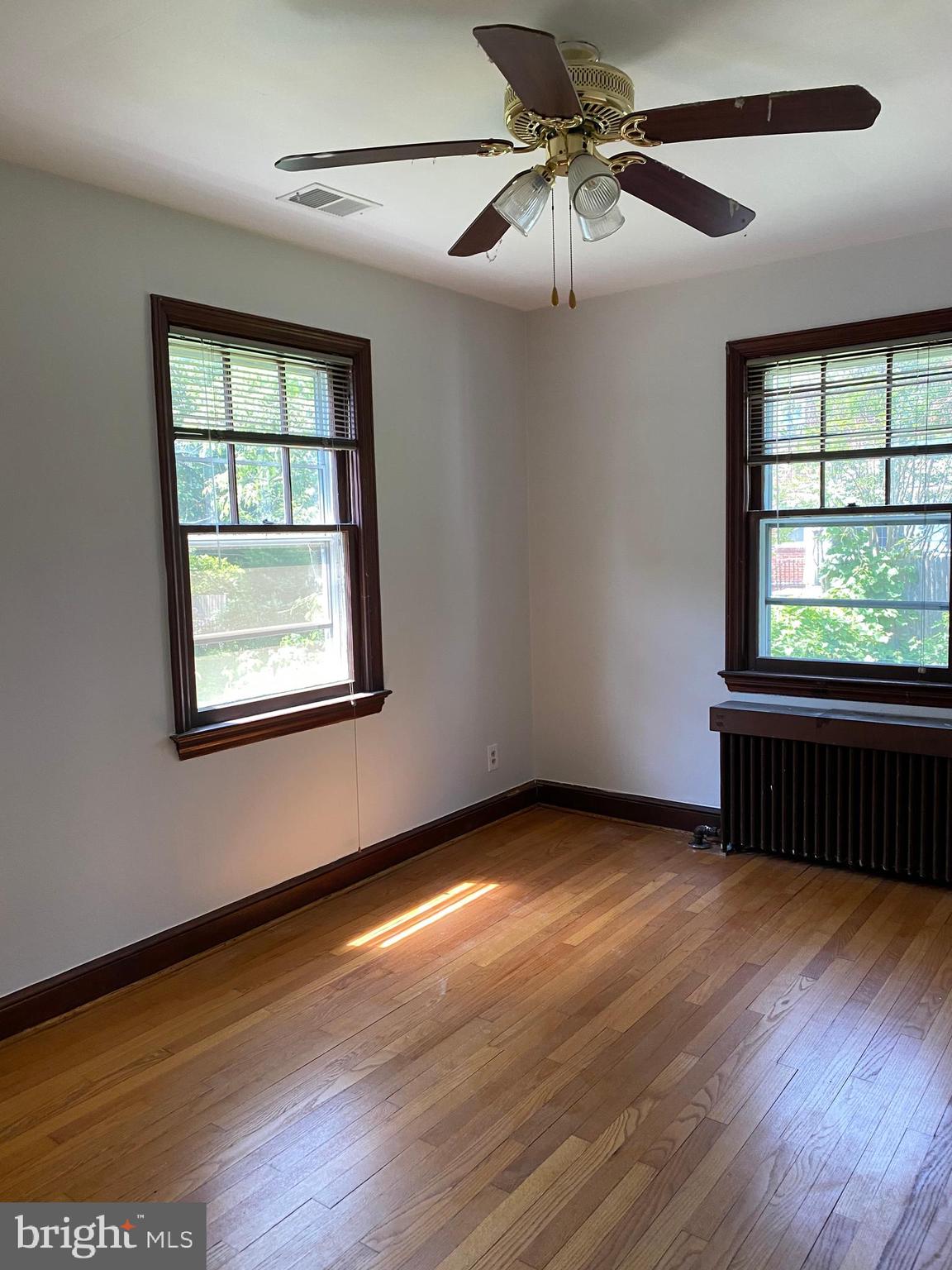 202 East Spring Street Alexandria, VA 22301 - Photo 14 of 45 a view of an empty room with wooden floor and a window