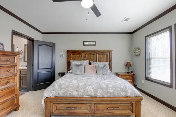 a bedroom with a large bed and a window