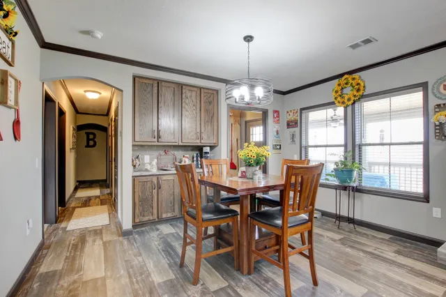a view of a dining room with furniture window and wooden floor