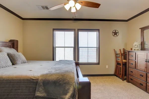 a bedroom with a bed and a chandelier