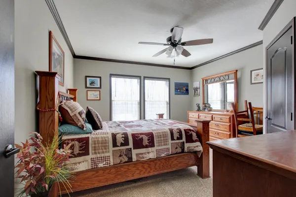 a bedroom with a bed and a chandelier