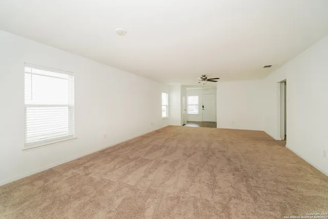 an empty room with windows and closet