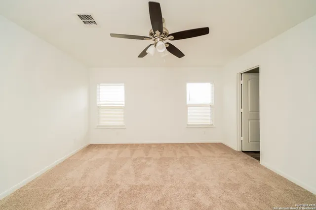 a view of room with a ceiling fan