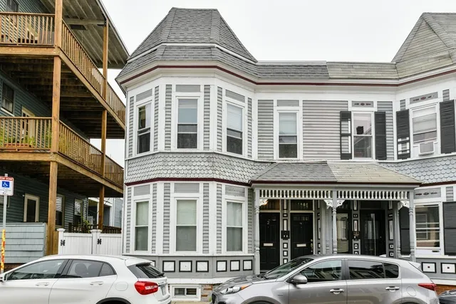 a front view of a building with a parking space