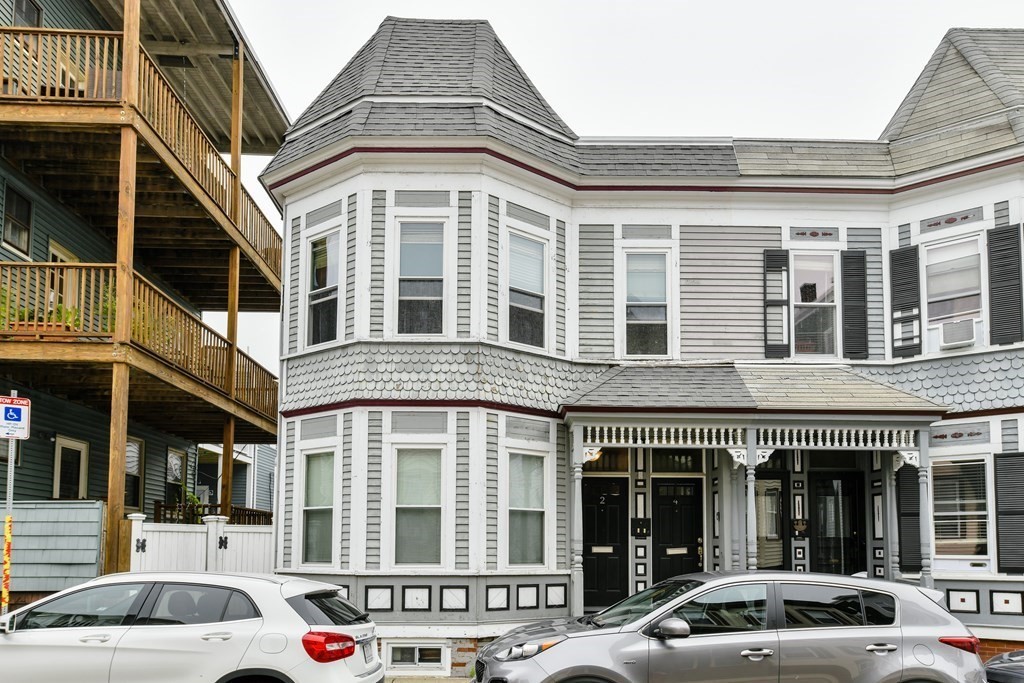 a front view of a building with a parking space