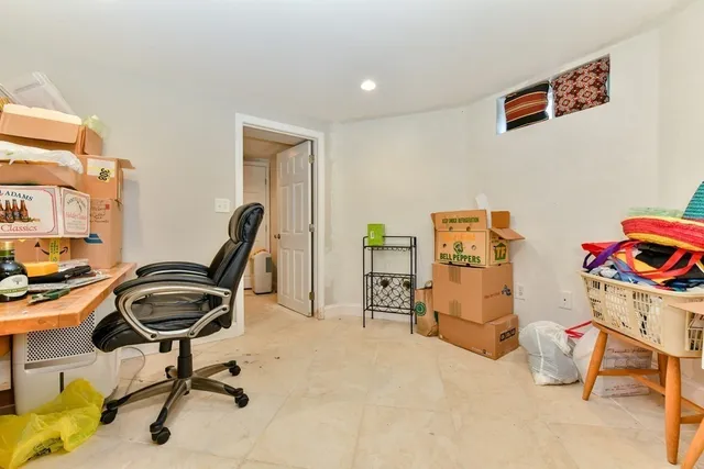 a view of a workspace with furniture and a window