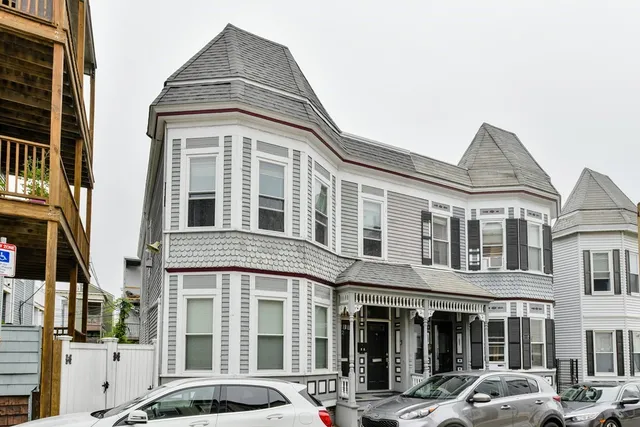 a front view of a residential apartment building with a yard