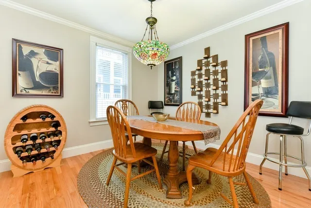 a view of a dining room with furniture and chandelier