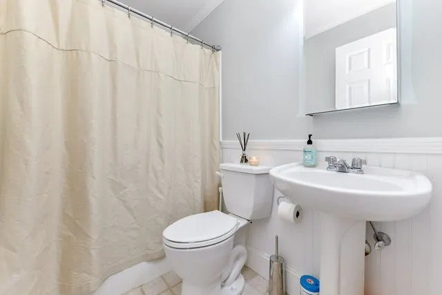 a bathroom with a sink a toilet and mirror
