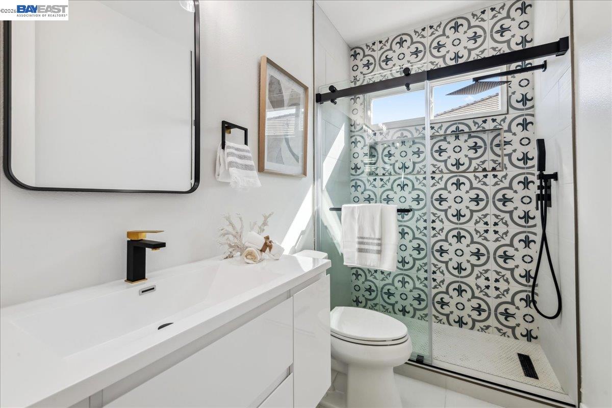 2890 Sable Oaks Way Dublin, CA 94568 - Photo 36 of 60 a bathroom with a sink a toilet and shower curtain