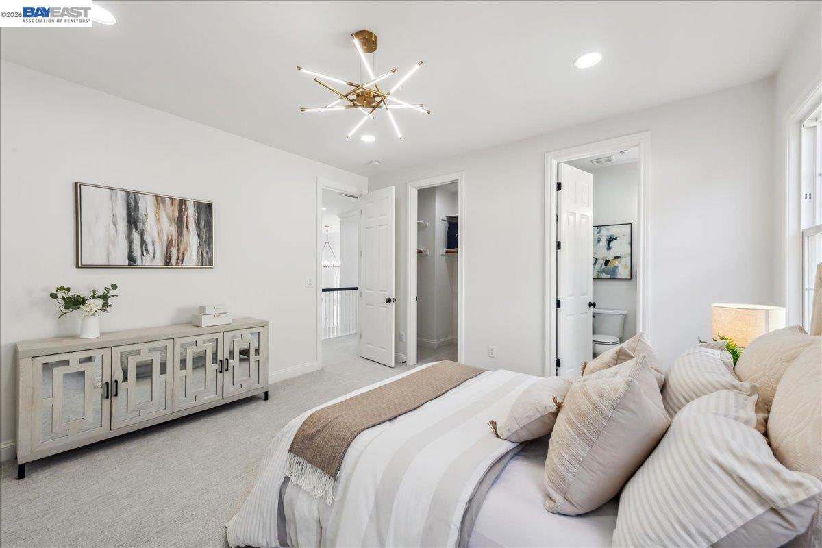 2890 Sable Oaks Way Dublin, CA 94568 - Photo 38 of 60 a bedroom with a bed and a chandelier
