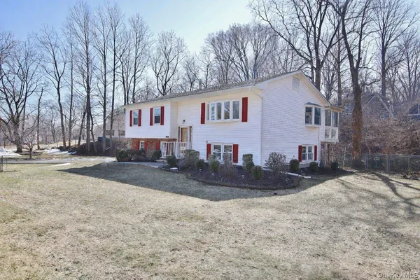 a front view of a house with a yard covered with snow