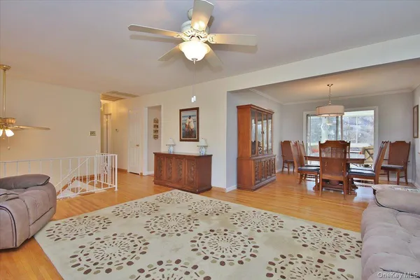 a living room with furniture or chandelier and a dining table