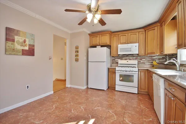 a kitchen with a stove a refrigerator and a sink