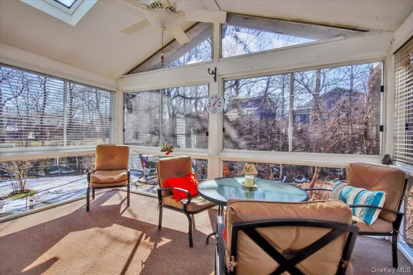 a dining room with furniture and a floor to ceiling window