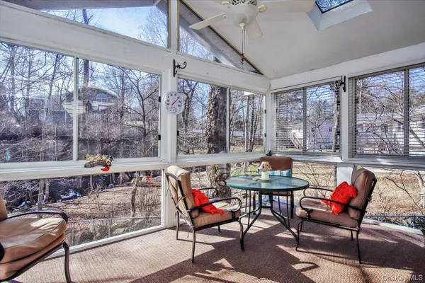 a living room with furniture and a floor to ceiling window