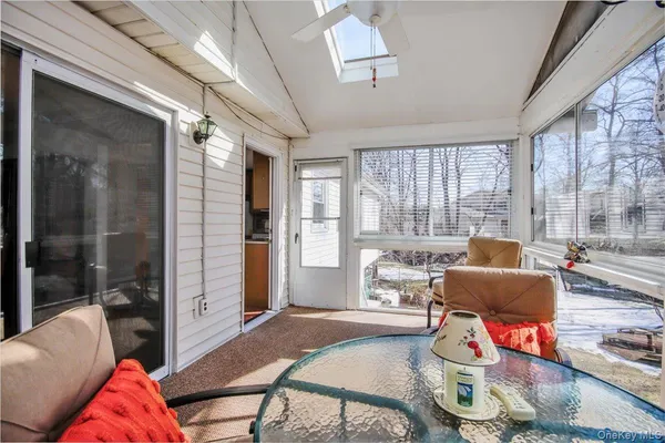 a living room with furniture and a floor to ceiling window