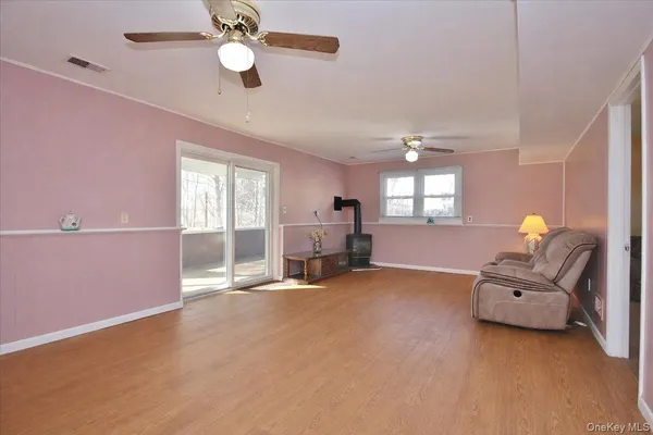 a view of livingroom with furniture chandelier fan and windows