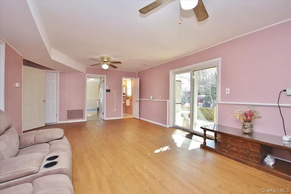 a living room with furniture and a floor to ceiling window