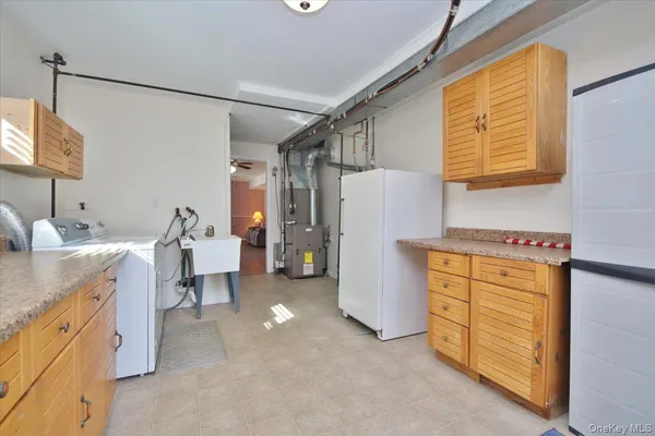a utility room with cabinets washer and dryer