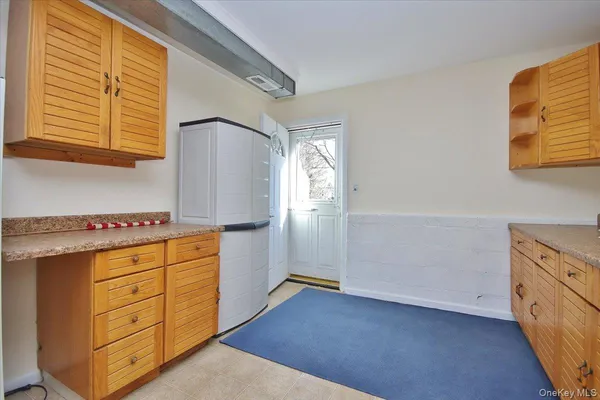 a kitchen with cabinets appliances and a window
