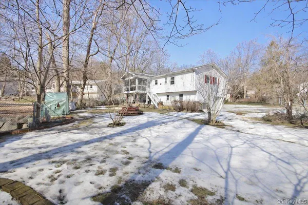 a view of a yard with snow on the road