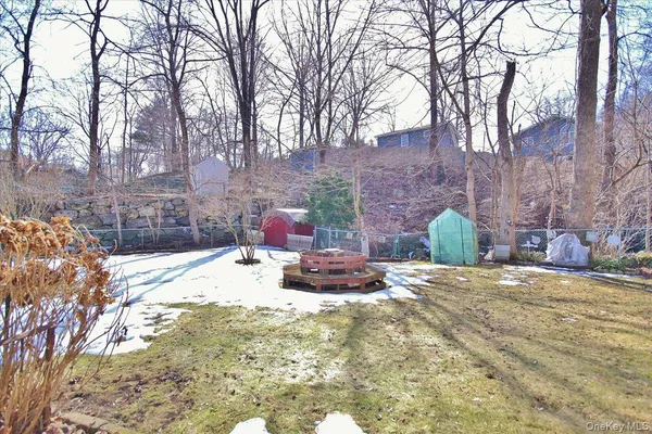 a backyard of a house with fire pit and chairs
