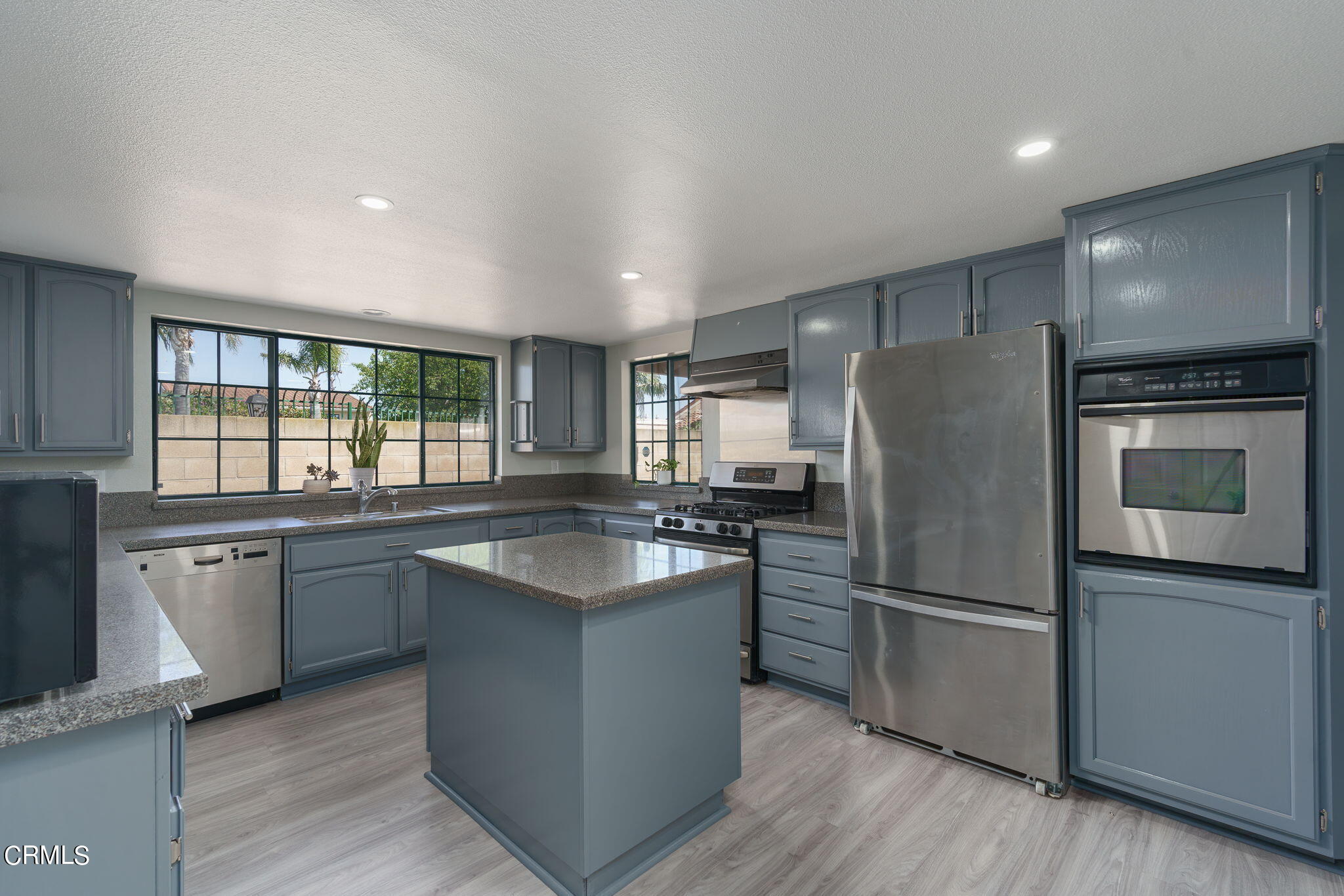 2940 Fanshell Walk Oxnard, CA 93035 - Photo 18 of 40 a kitchen with stainless steel appliances granite countertop a refrigerator a stove a sink and a microwave