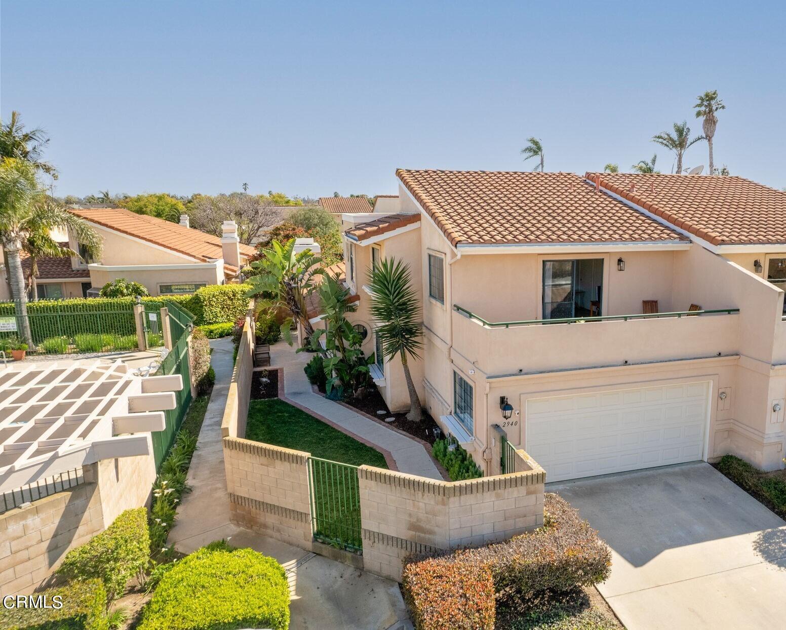 2940 Fanshell Walk Oxnard, CA 93035 - Photo 2 of 40 a view of a house with a white roof and wooden fence