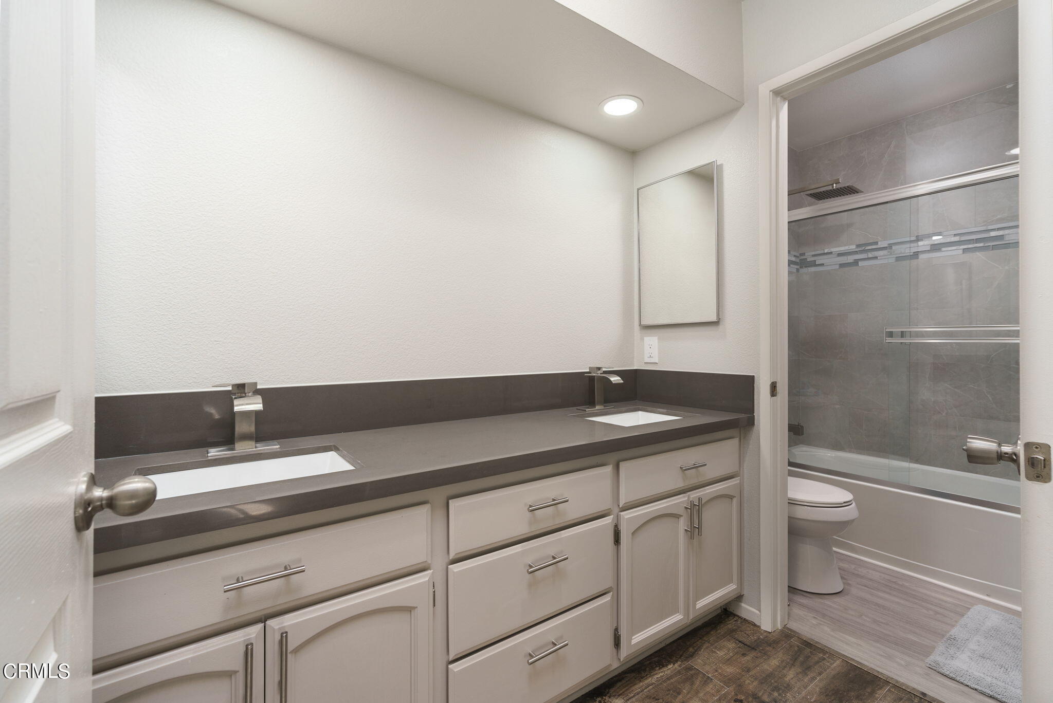 2940 Fanshell Walk Oxnard, CA 93035 - Photo 32 of 40 a bathroom with a granite countertop sink a toilet and shower