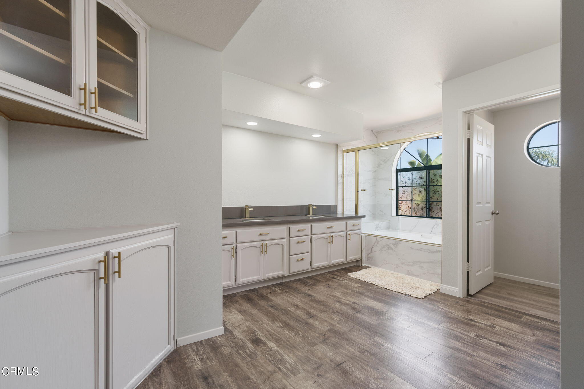 2940 Fanshell Walk Oxnard, CA 93035 - Photo 6 of 40 a large kitchen with a wooden floor and cabinets