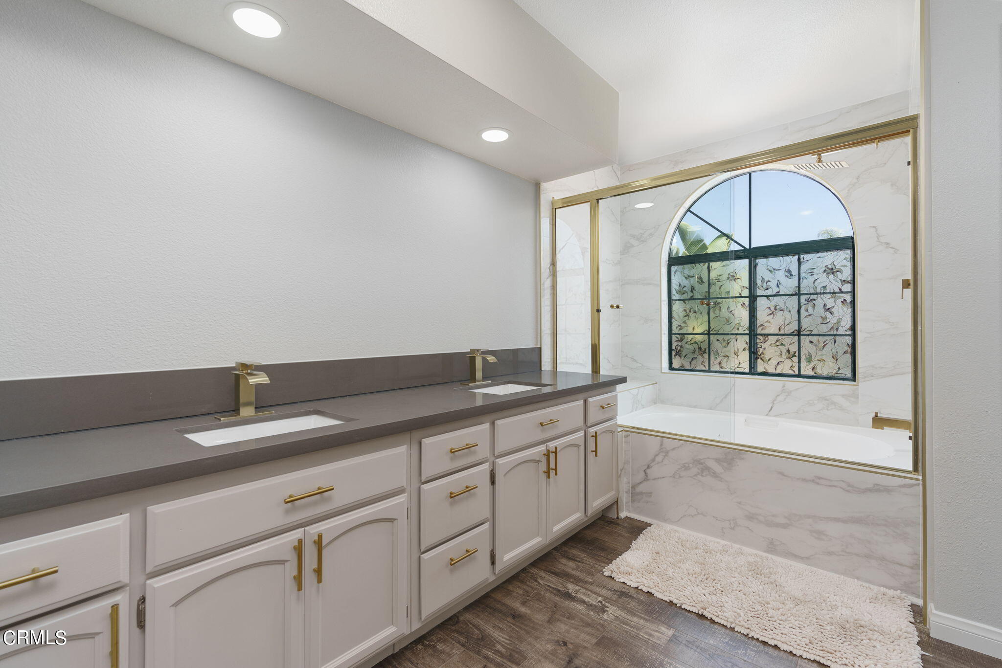 2940 Fanshell Walk Oxnard, CA 93035 - Photo 7 of 40 a spacious bathroom with a granite countertop tub a sink and a large window
