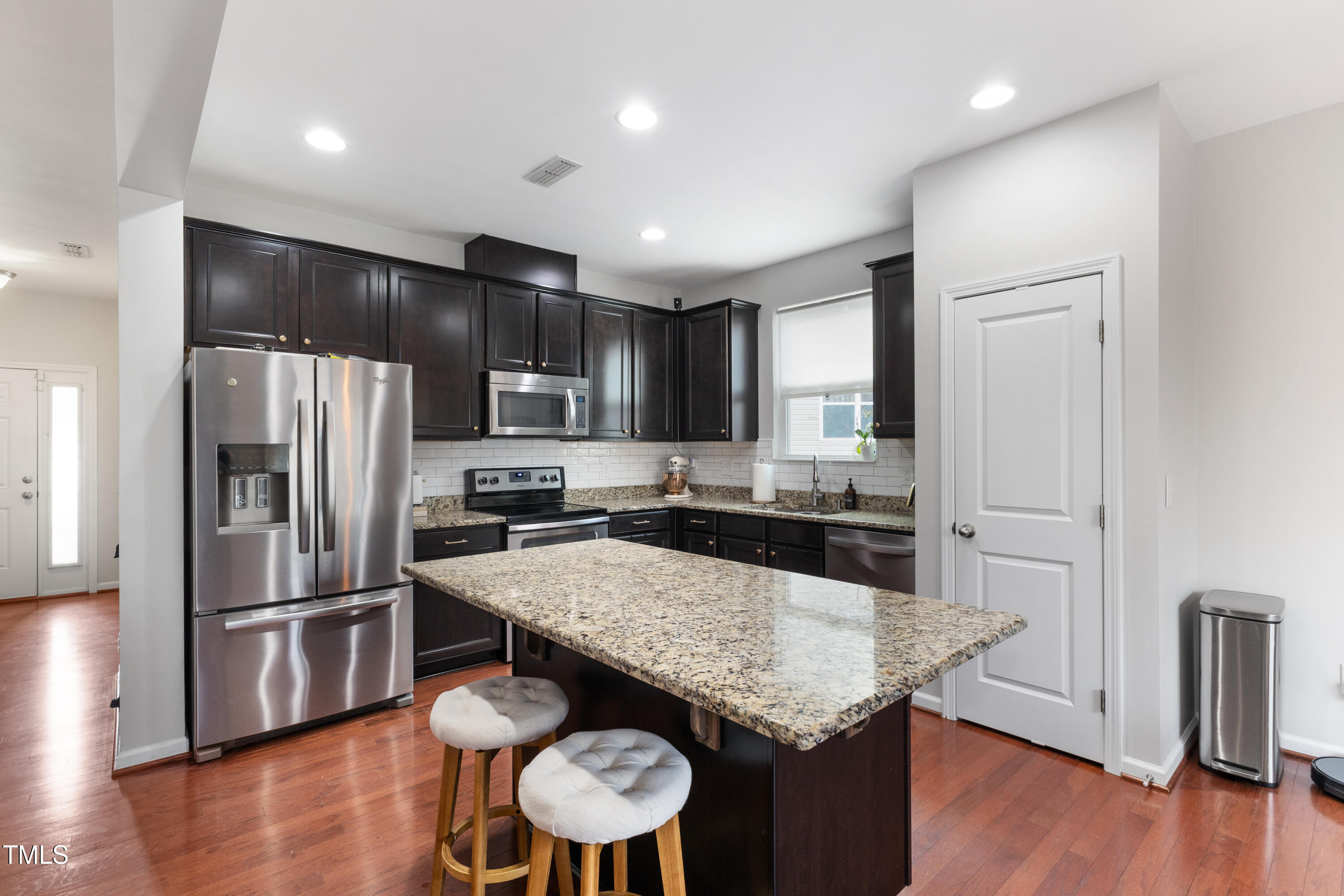 617 Hope Valley Road Knightdale, NC 27545 - Photo 10 of 42 a kitchen with granite countertop kitchen island wooden floor center island and stainless steel appliances