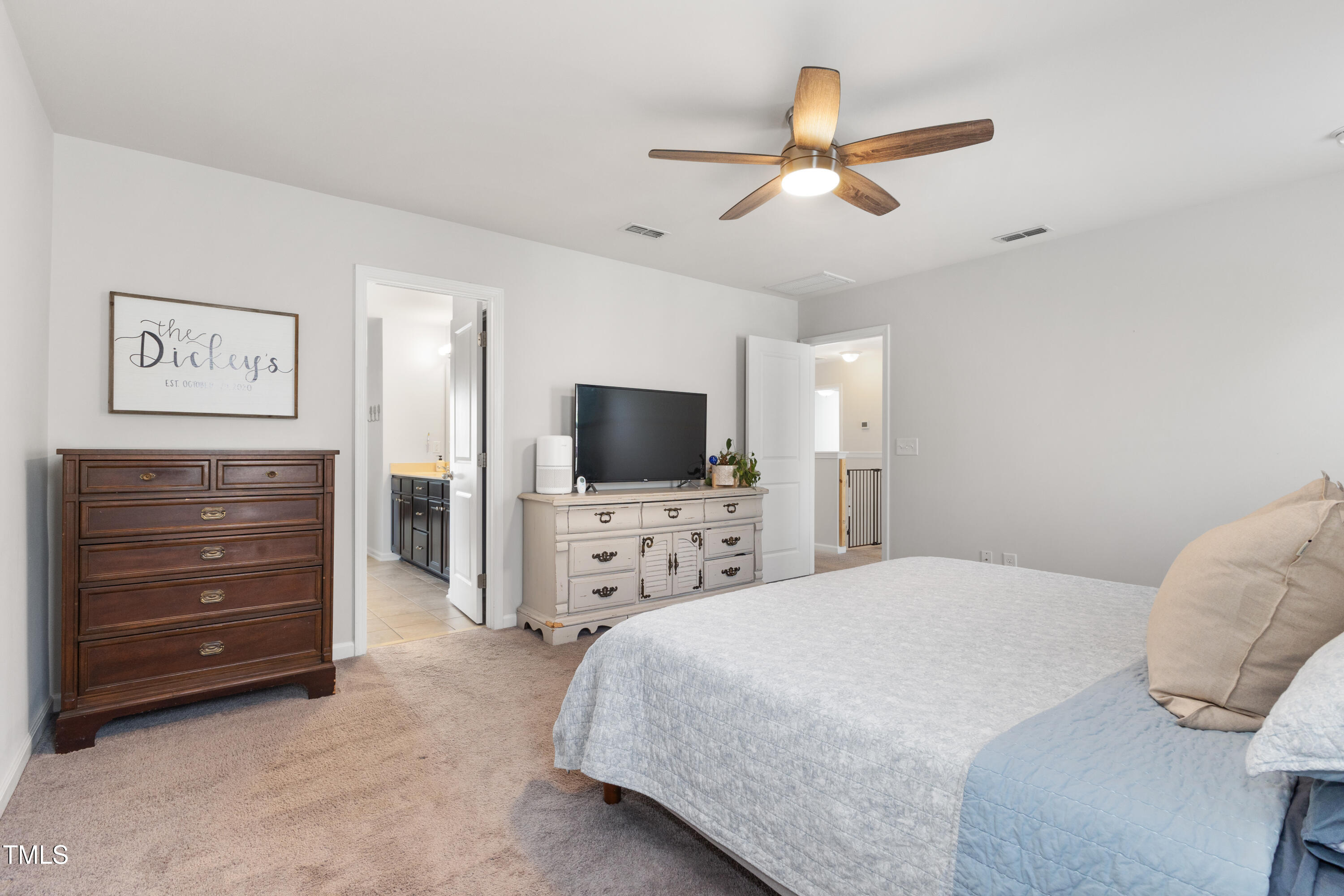 617 Hope Valley Road Knightdale, NC 27545 - Photo 17 of 42 a bedroom with a bed and a flat screen tv
