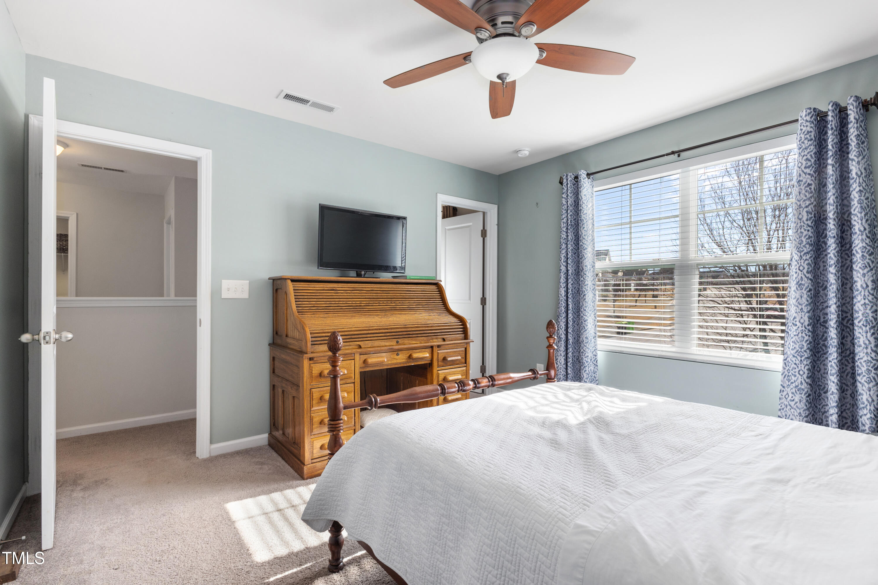 617 Hope Valley Road Knightdale, NC 27545 - Photo 24 of 42 a bedroom with a bed and a flat screen tv