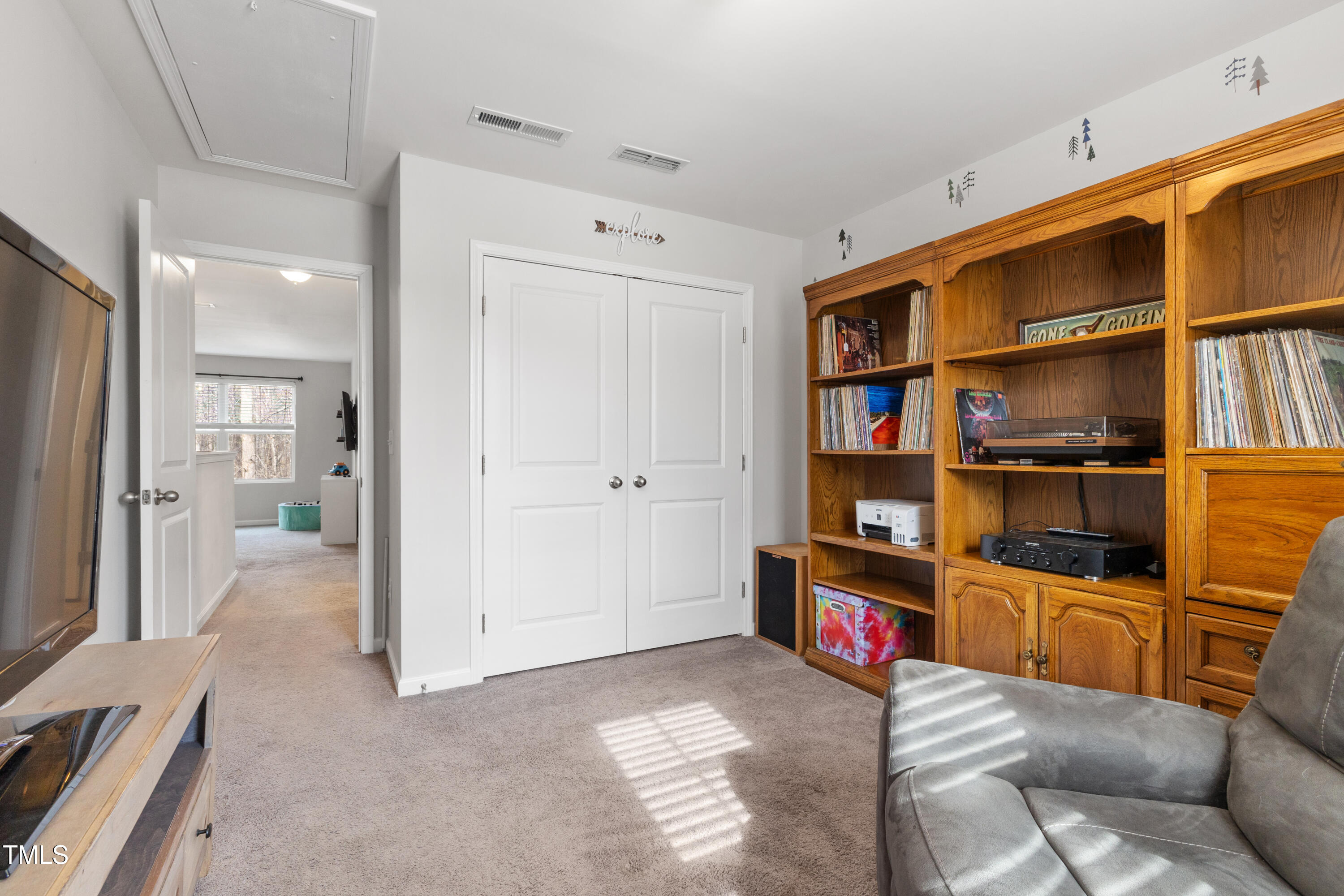617 Hope Valley Road Knightdale, NC 27545 - Photo 26 of 42 a living room with furniture and a book shelf
