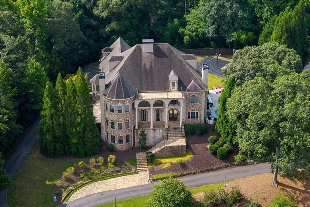 an aerial view of a house with a yard