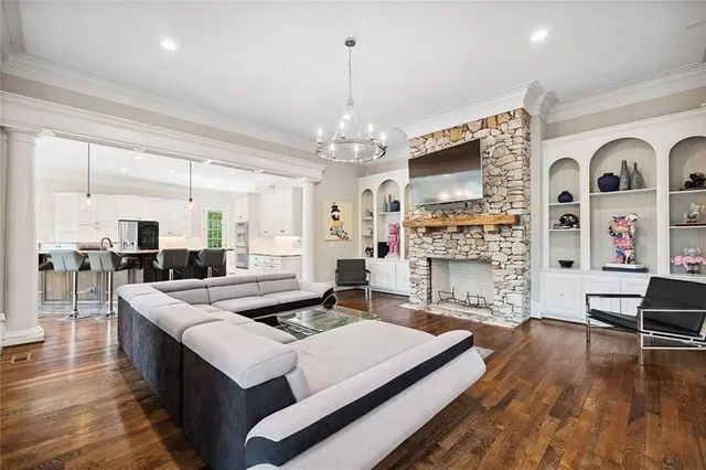 a kitchen with kitchen island granite countertop a sink stove and refrigerator