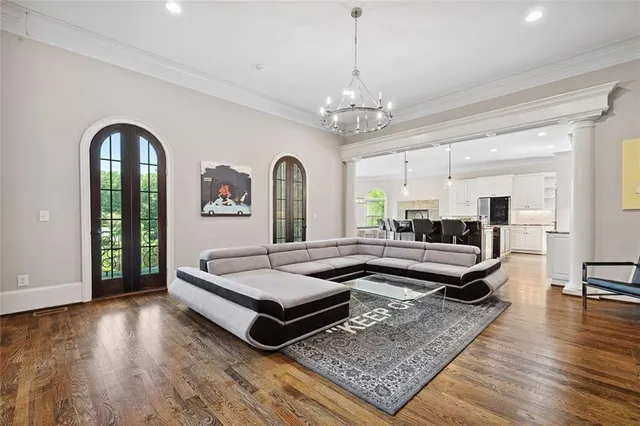 a living room with furniture a flat screen tv and a large window