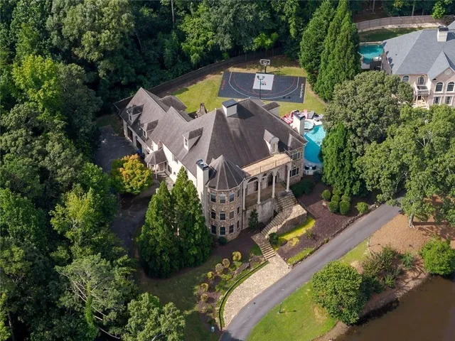 a swimming pool with lots of tress in the background
