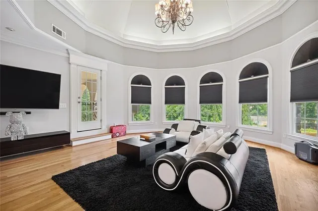 a spacious bedroom with a bed and a chandelier