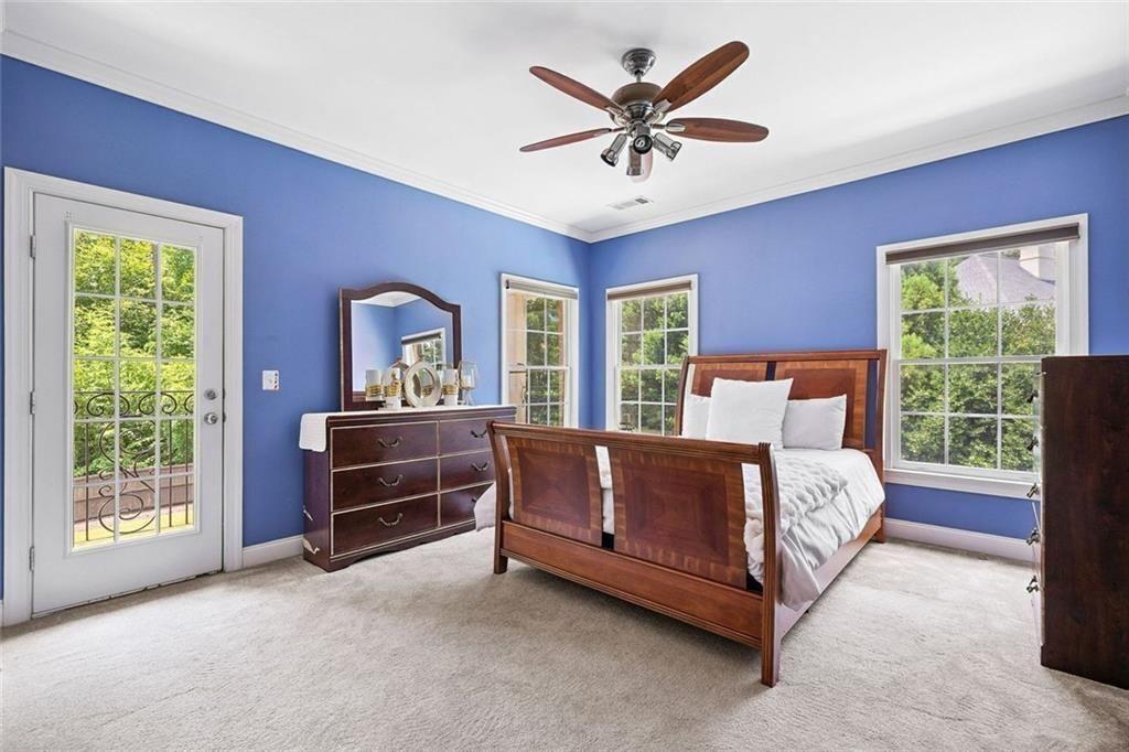 11140 W Road Roswell, GA 30075 - Photo 40 of 72 a bed sitting in a bedroom next to a window