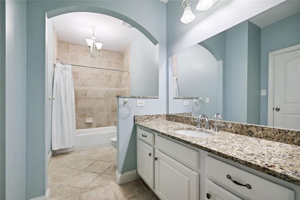 11140 W Road Roswell, GA 30075 - Photo 43 of 72 a spacious bathroom with a granite countertop sink a mirror and a shower