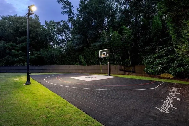 a room with lots of white furniture and wooden floor
