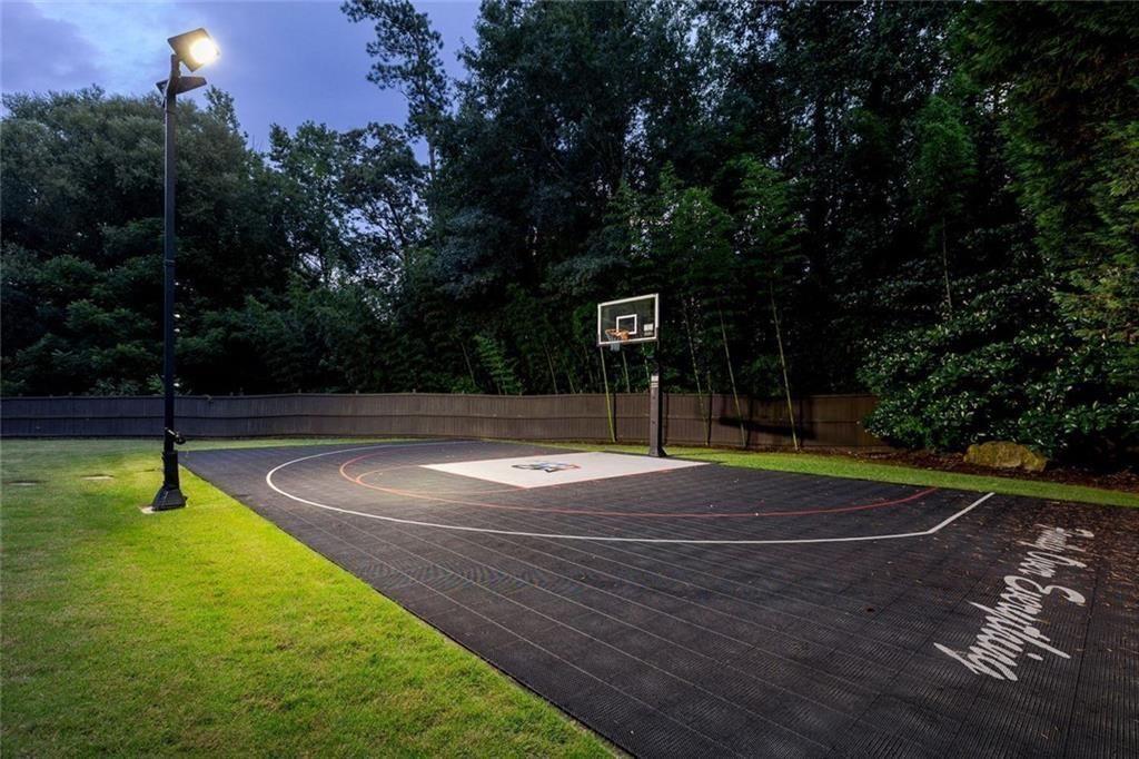 11140 W Road Roswell, GA 30075 - Photo 6 of 72 a swimming pool with lots of tress in the background