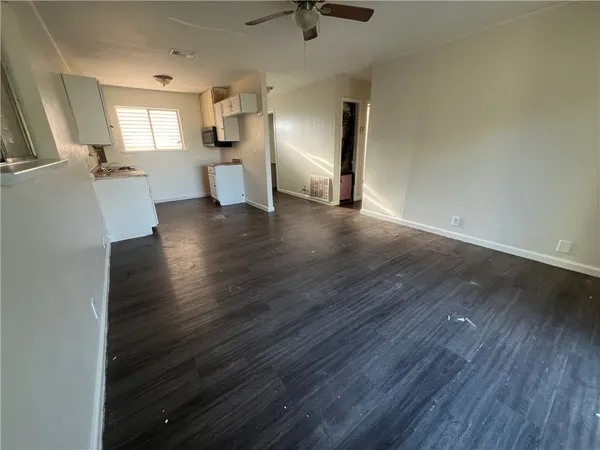 a view of a kitchen with a sink and a refrigerator